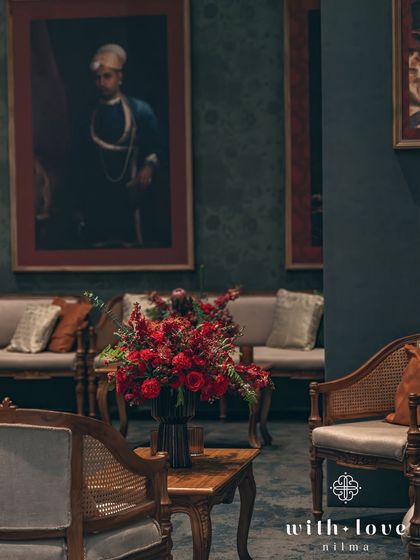 A classic seating arrangement with rich floral decor. The entire setup is designed to feel like a scene from a historical period drama, full of elegance and romance.