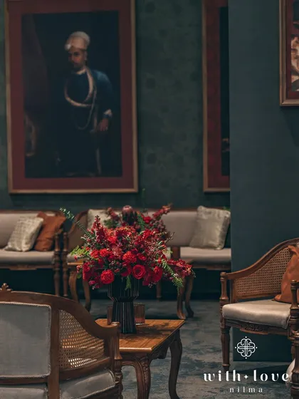 A classic seating arrangement with rich floral decor. The entire setup is designed to feel like a scene from a historical period drama, full of elegance and romance.