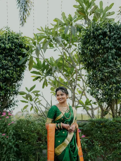 Another elegant shot of the bride surrounded by greenery.