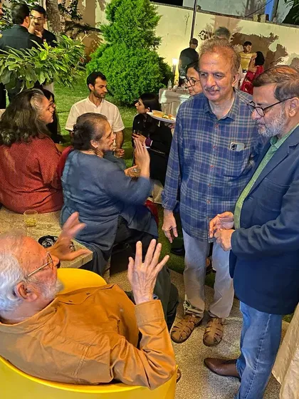 Gulammohammed Sheikh in an animated conversation with fellow artists.