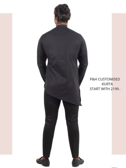 The back view of the black asymmetrical kurta, highlighting its unconventional design.