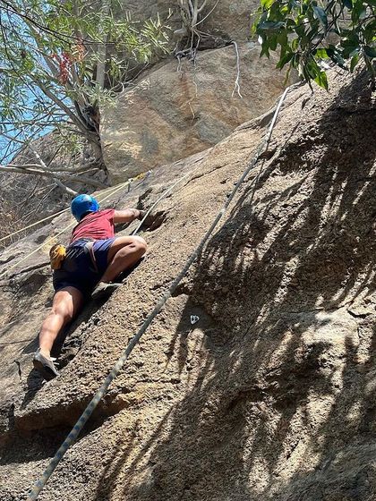 A climber works their way up a route during our 39th Intro Workshop. Even in the summer heat, the shade of the crag and the high spirits of the group make for a perfect day of climbing.
