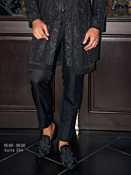 A detail shot of the black-on-black hand embroidery, showing the texture and craftsmanship that goes into each piece.