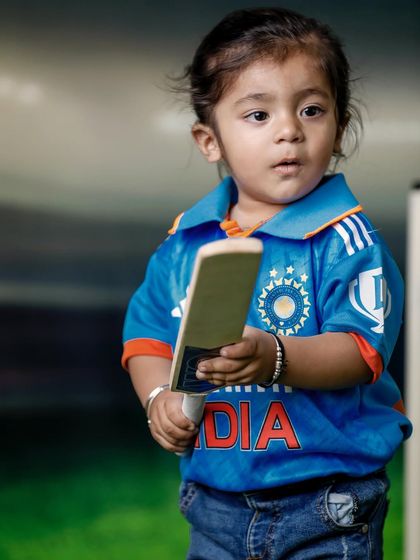 Ready to take a swing. This photo captures the anticipation and excitement of a child ready to play, making for a dynamic and engaging sports portrait.