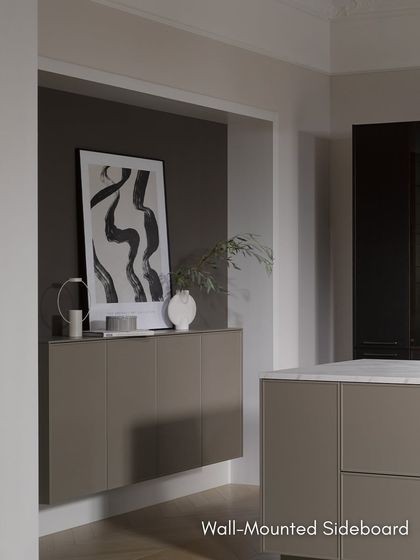 A wall-mounted sideboard in the same finish as the kitchen island extends the design into the living space, creating a cohesive and sophisticated look.