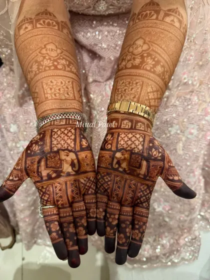 The rich, dark stain of an engagement design, showcasing elephant motifs and auspicious symbols, perfect for a traditional ceremony.