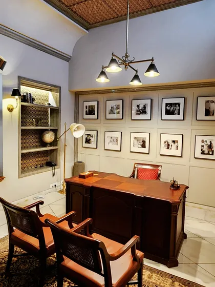 This home office, designed for a renovated bungalow in the Lutyens Delhi area, is a study in functional elegance. We created a gallery wall to celebrate the client's personal journey, paired with classic wooden furniture and carefully selected lighting to build a sophisticated and inspiring work ambiance.
