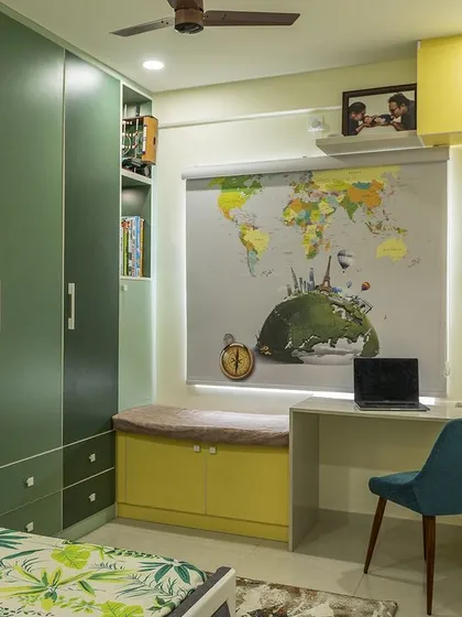 We believe kids' rooms should be fun and functional. This travel-themed bedroom features a vibrant green and yellow palette, a custom world map blind, and an integrated study desk with a bay window seat, creating a space that inspires creativity and adventure.