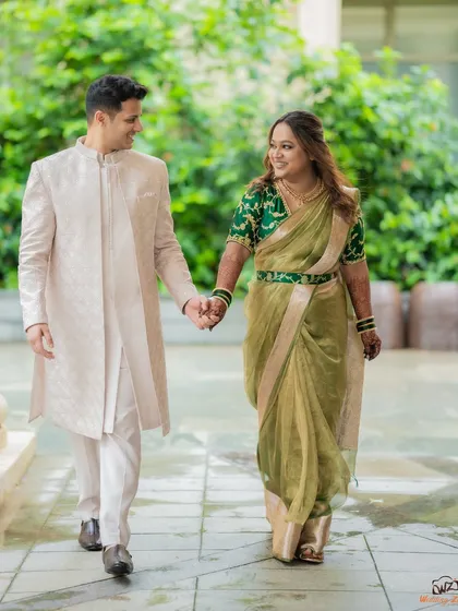 A classic walking shot of the couple holding hands. This type of photo feels dynamic and tells the story of them moving forward together.