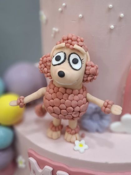 The poodle character from the Bluey cake, with detailed, textured fondant fur.