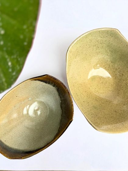 Our uniquely shaped snack bowls are perfect for munchies. This one has a Tenmoku rim that contrasts with the lighter glaze inside.