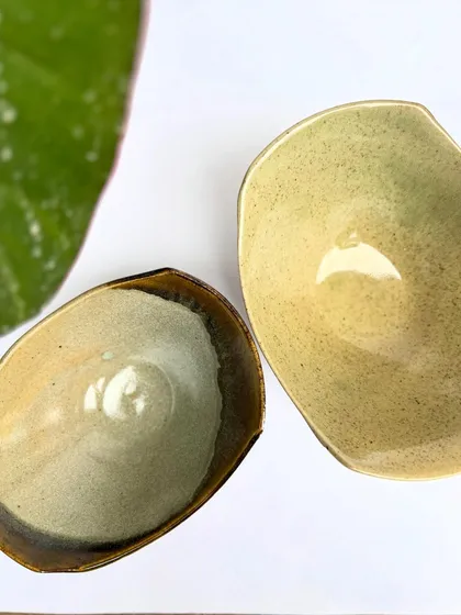 Our uniquely shaped snack bowls are perfect for munchies. This one has a Tenmoku rim that contrasts with the lighter glaze inside.