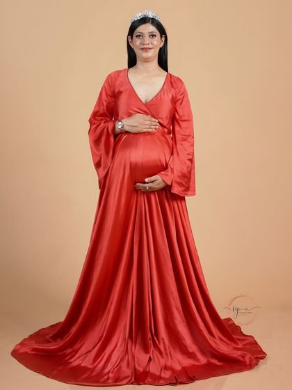 A simple and elegant solo portrait. The mom-to-be wears a beautiful tiara, adding a touch of royalty to her maternity look.