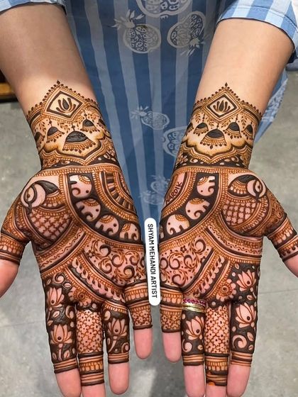 A beautiful, full-palm design featuring elephants and lotus flowers, with a matching pattern on the back of the hands.