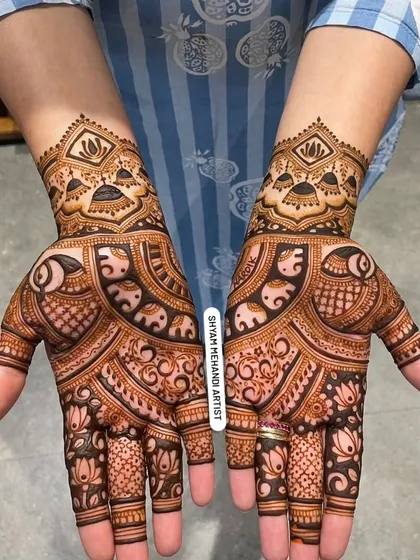A beautiful, full-palm design featuring elephants and lotus flowers, with a matching pattern on the back of the hands.