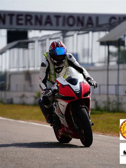 A rider in zen mode on an Aprilia, cruising down the pit lane exit. The moment of calm before you unleash the power on the main straight.
