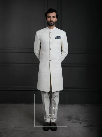 A creation where culture meets couture. My ivory handloom silk sherwani, paired with a paisley stole, is heritage woven with love, making every wearer feel regal and timeless.