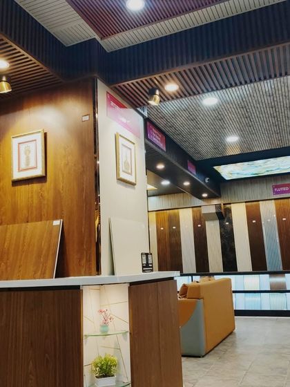 A view of our reception desk and the adjacent wall, which is clad in beautiful wood-finish panels.