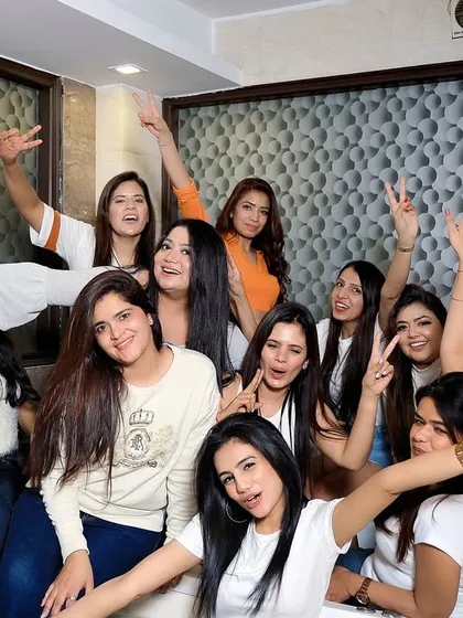 All smiles and peace signs! A happy group photo capturing the fun and playful energy of the bride tribe.