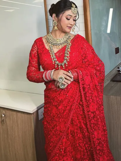 A series of a model in a beautiful red lace saree. This classic yet modern piece is versatile enough for a bridal trousseau shoot or a festive occasion.