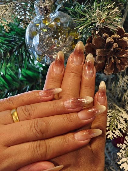 A beautiful set of long, ombre nails with a touch of sparkle, perfectly matching the Christmas tree decorations.