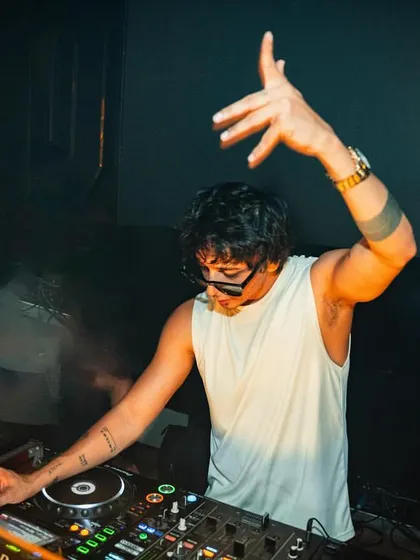 A close-up of me in action at the console in Pune. This shot highlights my focus and technical skill as a DJ.