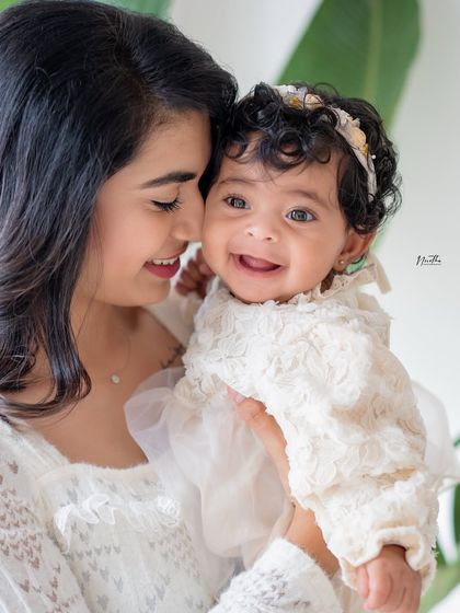 A close-up of a mother and her smiling baby girl.