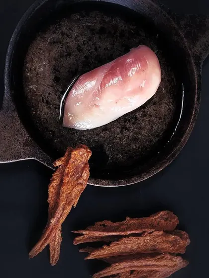 This is our promise of quality, shown in a single image. We start with fresh, human-grade chicken breast and gently dehydrate it to lock in all the natural flavor and nutrients, creating a pure and simple dog treat.
