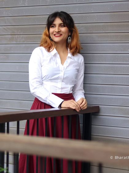 Capturing a candid, happy moment against a modern, textured wall. This shows the blend of professional and personal styles we can achieve.