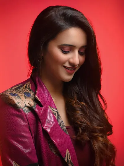 Even within a moody setup, we can capture moments of warmth. The soft smile and downward gaze create a sweet, candid-feeling moment, adding another layer of personality to her portfolio.