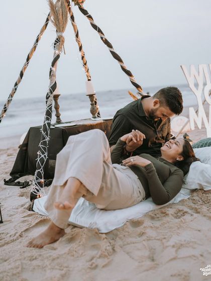 A candid moment of laughter and connection during a beach proposal setup. I focus on capturing the genuine emotions that make your pre-wedding photography special.