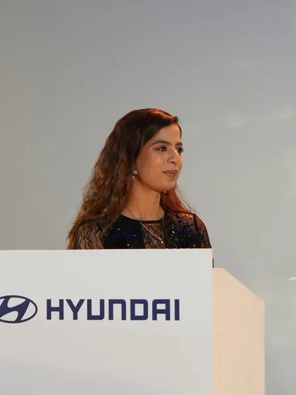 A poised moment at the Hyundai podium. For corporate clients, maintaining a polished and professional demeanor is key.