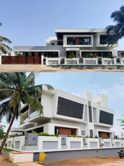 The modern, cubist facade of the 'Vijaya Basava' residence is characterized by interlocking white volumes and large glazed openings.