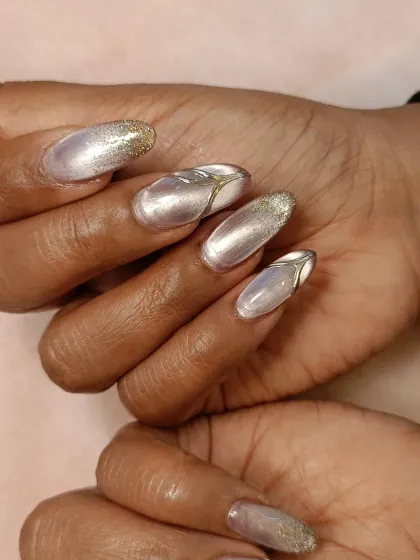 A side view of the cat-eye and chrome nails, highlighting the elegant almond shape of the extensions and the way the light catches the different finishes.