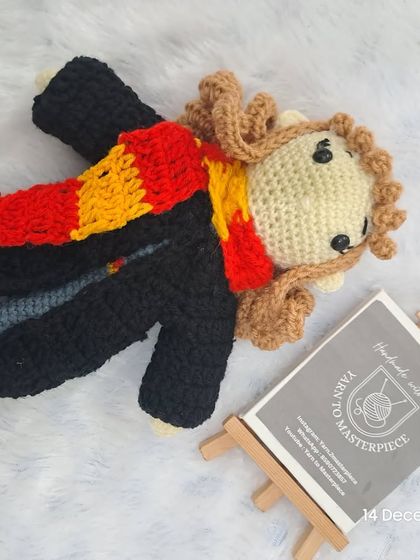 Here is my Hermione Granger doll, a perfect companion for Harry. She has her own Gryffindor scarf and bushy hair, ready for a magical adventure.