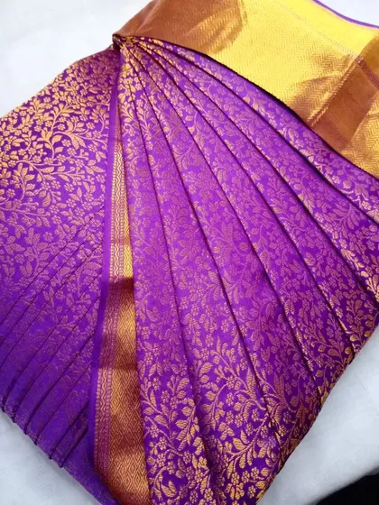 A stunning purple Kanjeevaram saree with all-over gold weaving.