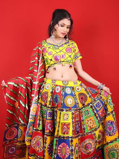 Happy Navratri! This model is wearing a bright yellow and multi-colored lehenga, with makeup that is equally vibrant and fun.