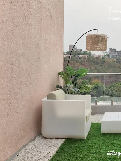 A closer look at the terrace from the Agra Fort Project. The clean lines of the modern outdoor furniture contrast beautifully with the soft texture of the artificial grass and the rugged landscape in the distance.