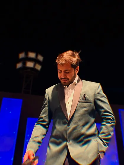 A moment of reflection on stage. Even in the midst of high energy, there are moments of quiet satisfaction.