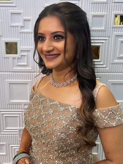 This Sangeet bride looks so happy and confident. The soft glam makeup and simple hairstyle let her beautiful embellished gown be the star of the show.