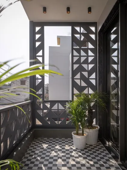 In a dense Meerut neighborhood, the Hikari House facade negotiates privacy and openness. We used custom cast-concrete screens, assembled like Tetris blocks, to filter views and soften sunlight, creating a serene balcony space that feels both connected to the city and peacefully secluded.