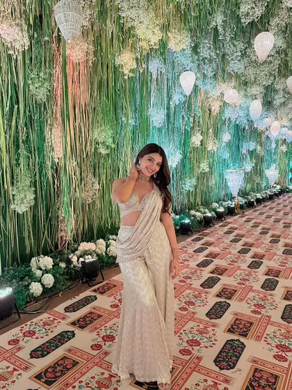A full-length view of this guest's elegant outfit. The makeup is polished and refined, completing a look that is perfect for a wedding celebration.