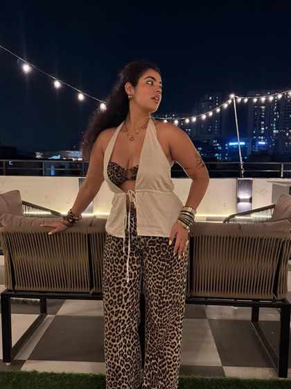 My favorite animal is me in animal print. This rooftop look with H&M leopard print pants and a thrifted linen top is all about bold, confident summer styling.