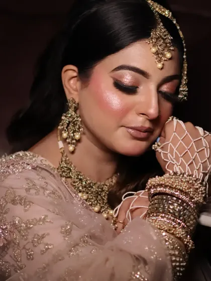 A mesmerizing close-up. This shot focuses on the glowing skin, the soft eye makeup, and the beautiful, intricate hand jewelry.