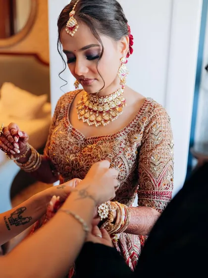 A behind the scenes moment, getting the final touches just right. This look for a destination wedding combined traditional elements with a flawless, long-lasting application.
