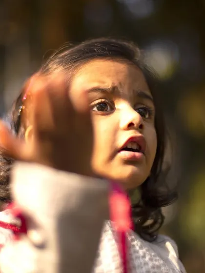 Reaching out with wonder. I love to notice the little things children do, as it shows what inspires them. This candid shot is a beautiful example of a child's natural curiosity.