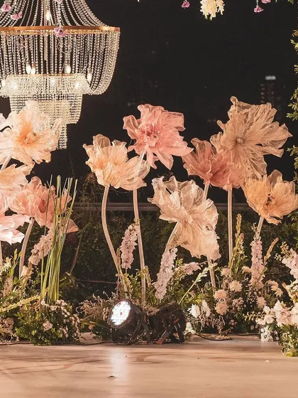 Another view of the whimsical, oversized paper flowers. Their soft, glowing light adds to the romantic and dreamy atmosphere of the evening reception.