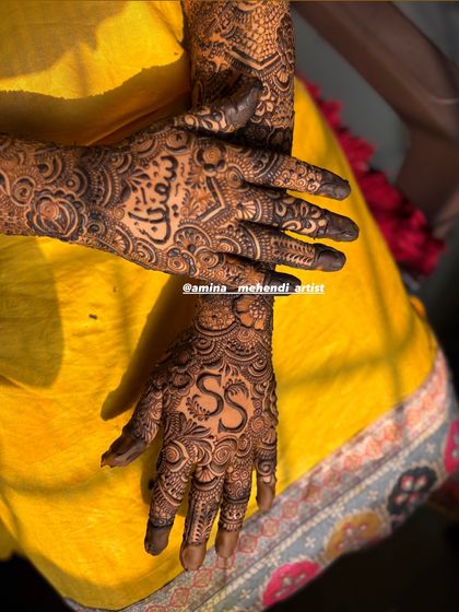 A close-up of personalized palms, featuring the initials 'S' and 'S' and a name in Arabic script.