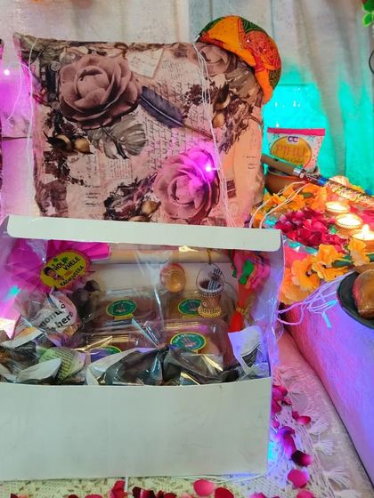 Another view of the Holi hamper, showing the festive packaging and the delicious homemade snacks inside.