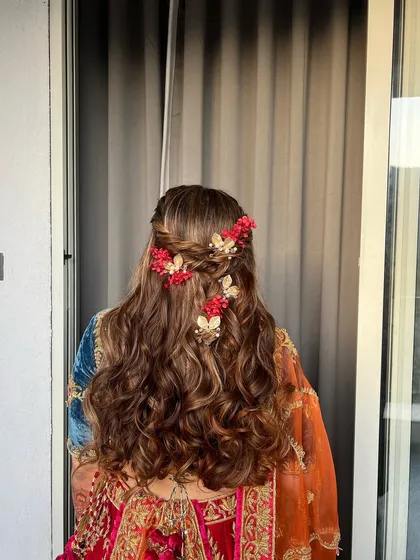A back view of the enchanting Mehendi hairstyle, showing the intricate details of the braids and accessories.